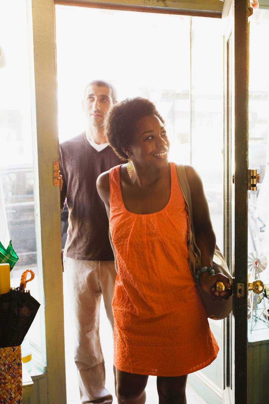 Real estate agent opening a door for her clients