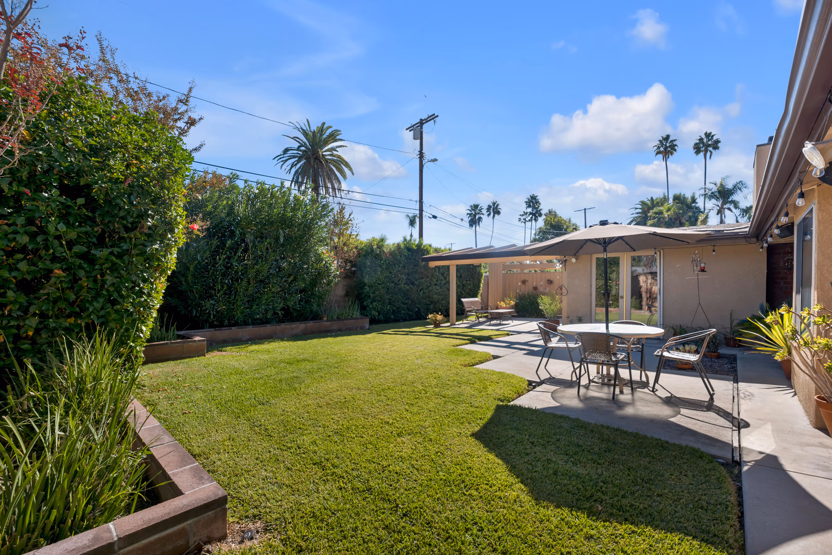 This Corbin Palms Mid Century Modern home was designed by renowned architects Dan Palmer & William Krisel. The homes open floor plan has 4 family bedrooms & 1.75 remodeled baths. The home is 1644 square feet situated on a 6900 square foot lot. The spacious sunlit living room has vaulted wood beam ceilings and is conveniently located adjacent to the dining room with lighted ceiling fan, family room with direct access to the backyard & remodeled kitchen. The family chef will love the remodeled kitchen with ample cabinets, quartz counters & backsplash, a newer range & microwave, refrigerator (included), newer dishwasher, dual basin stainless steel sink, large pantry & laundry room with washer/dryer (included). The living room has beautiful Parque wood floors & cozy floor to ceiling brick fireplace. The home’s many amenities include central AC/heat for year-round comfort, copper plumbing, newer roof, freshly painted exterior, remodeled kitchen, newer appliances, remodeled bathrooms & wood beam ceilings. You’ll enjoy entertaining family & friends in the lovely private backyard with lush mature landscaping, concrete patio & grassy play area. There’s a large concrete driveway and 2 car carport with storage. Close to orange line, World Class shopping, dining & entertainment at The Village at Warner Center & easy freeway access to the 101 freeway.